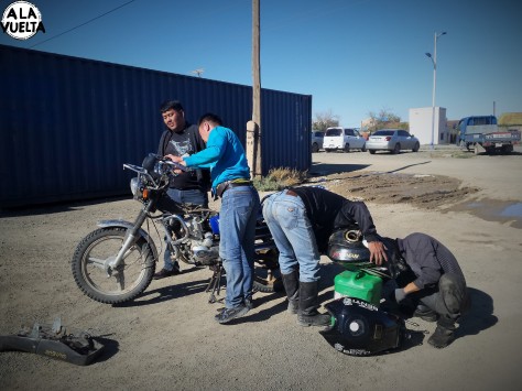 Cinco personas trabajan en la reparación del tanque de nafta de la moto de Germán.